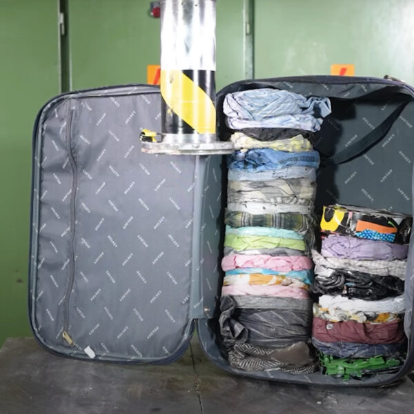 Packing A Suitcase With A 150-Ton Hydraulic Press To Maximize Space